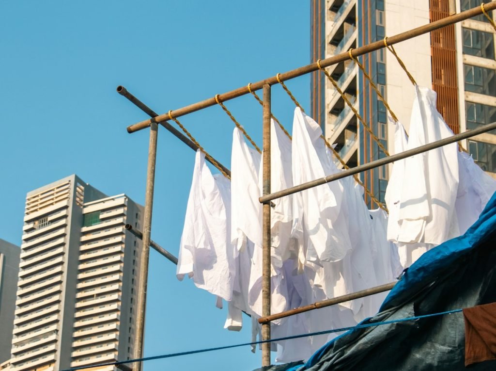 White shirts drying on a clothesline under a blue sky
