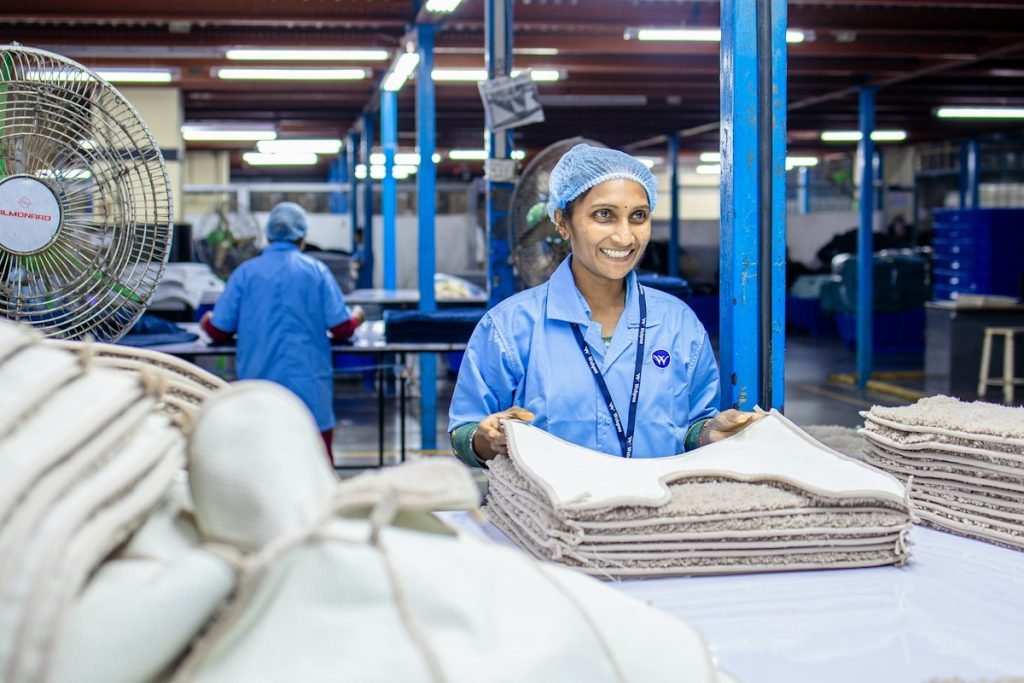 Laundry staff folding clean linen on a sorting table